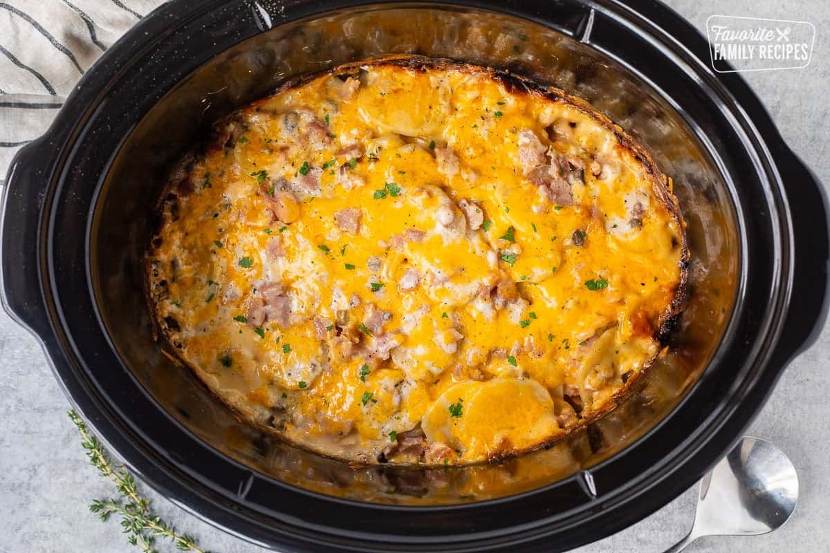 Crockpot ham and scalloped potatoes in a crockpot.