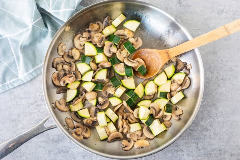 Skillet with mushrooms and zucchini.
