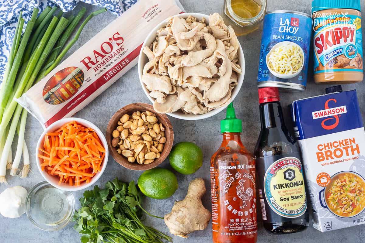 Ingredients to make Thai peanut noodles including velvet chicken, bean sprouts, peanut butter, chicken broth, soy sauce, sriracha sauce, ginger, limes, cilantro, peanuts, velvet chicken, honey, linguine, carrots, garlic, oil and green onion.