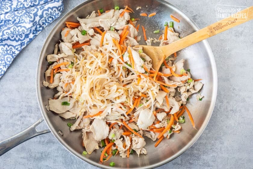 Bean sprouts added to skillet of velvet chicken, carrots and green onion.