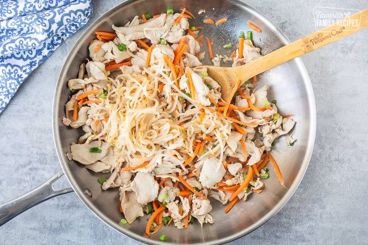 Bean sprouts added to skillet of velvet chicken, carrots and green onion.