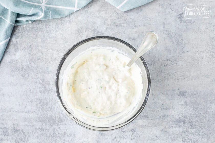 Small bowl of blue cheese dip with a spoon.