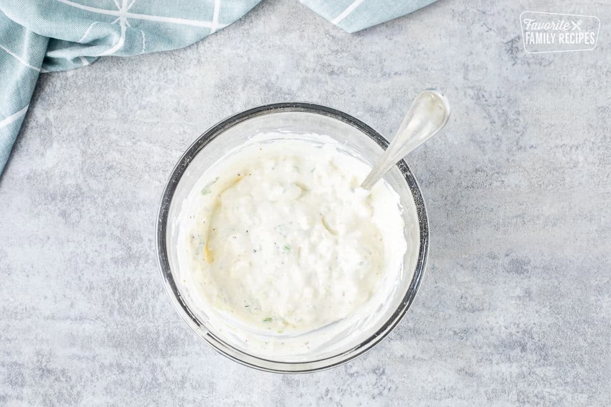 Small bowl of blue cheese dip with a spoon.