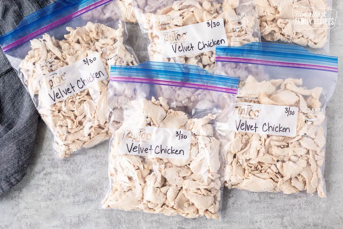 Ziplock bags of velvet chicken labeled for the freezer.