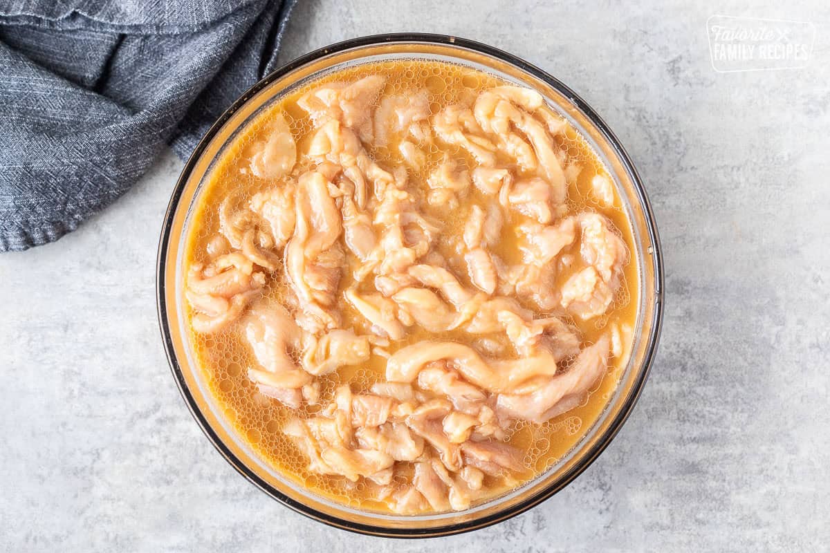 Marinating velvet chicken in a large bowl.