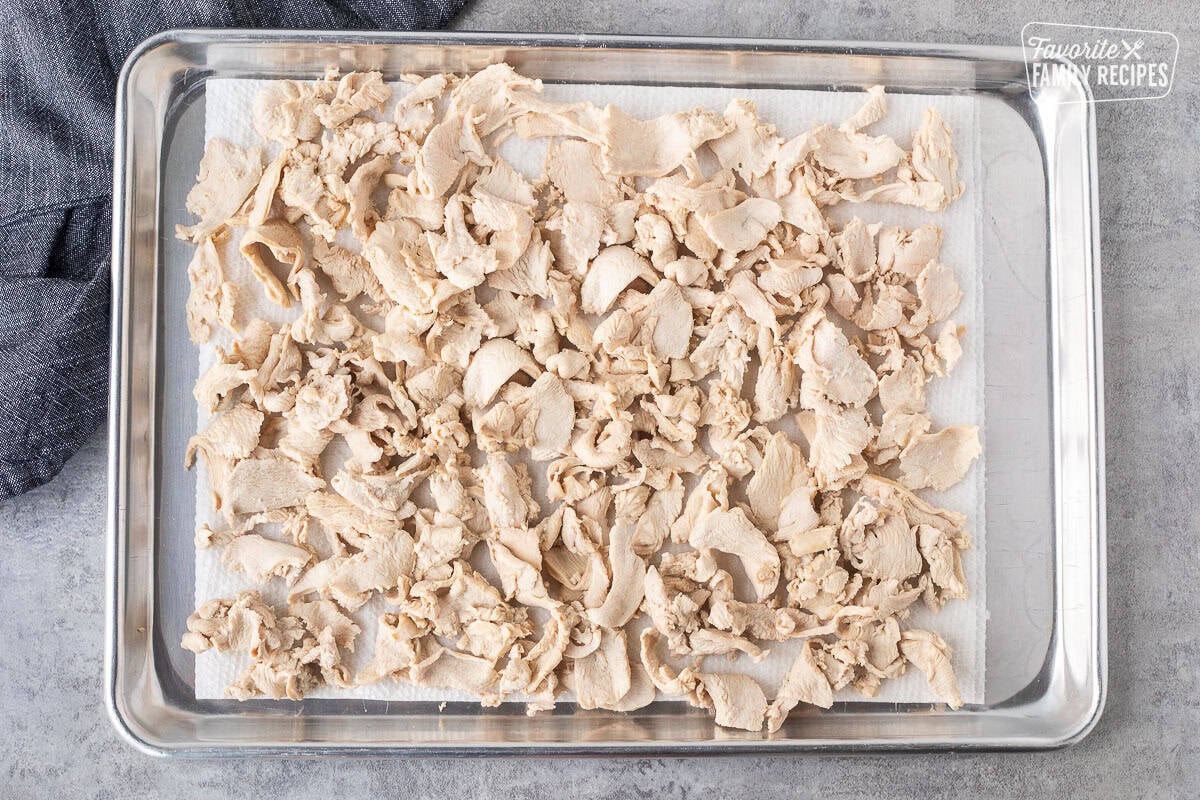 Sheet of cooked velvet chicken over paper towels.