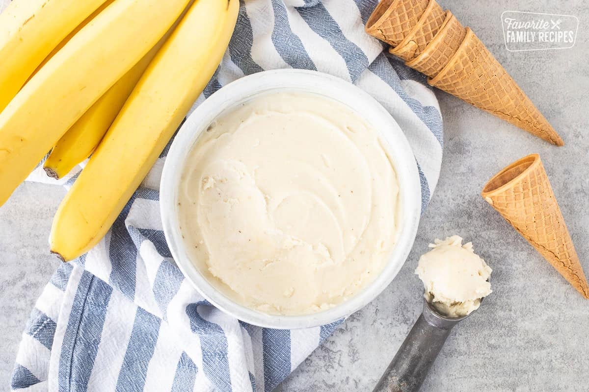 Scooped banana ice cream in an ice cream scoop.