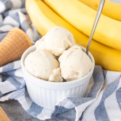Three scoops of banana ice cream in a small dish and a spoon.