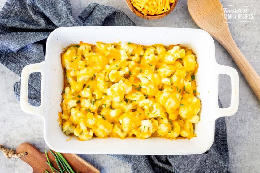 Cheesy Cauliflower Side Dish baked in a dish and garnished with chives.