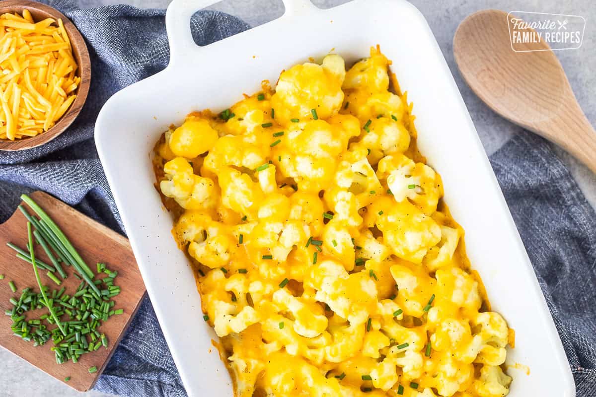Cheesy Cauliflower Side Dish baked in a dish and garnished with chives.