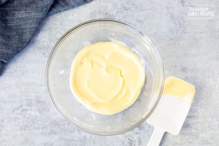 Small glass bowl with combined sauce and spatula.