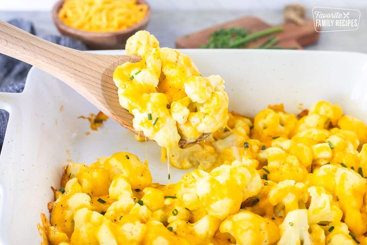 Wooden spoon with Cheesy Cauliflower Side Dish.