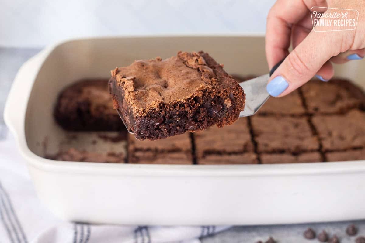 Spatula with a homemade brownie from the baking dish.