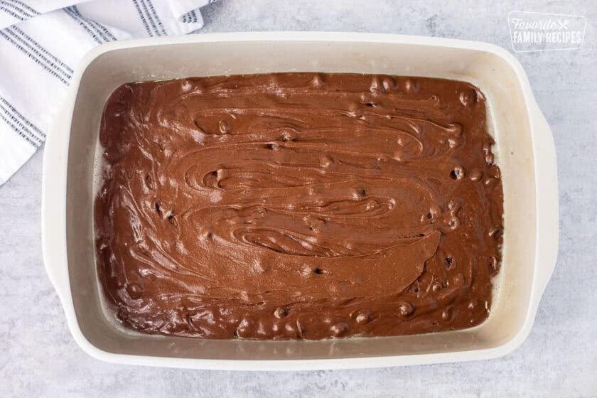 Brownie batter in a sprayed baking dish.
