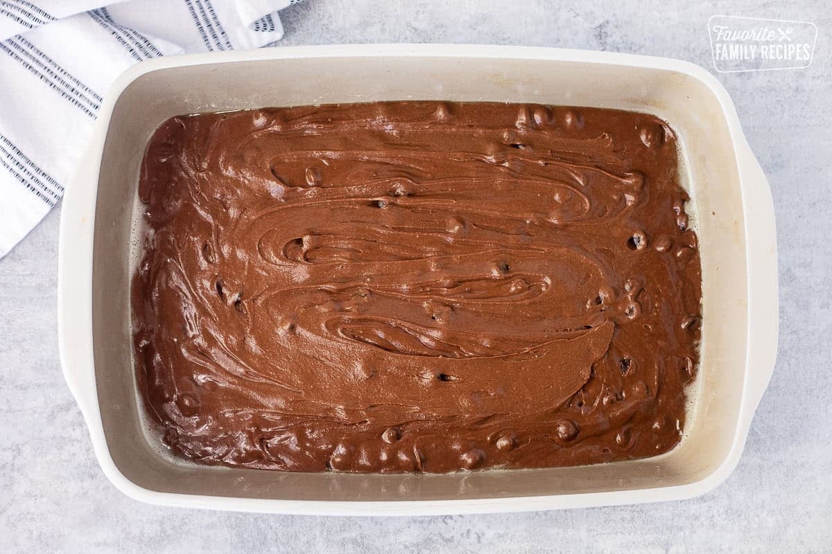 Brownie batter in a sprayed baking dish.