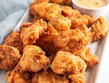 Mafa Chicken with dipping sauce on a platter.