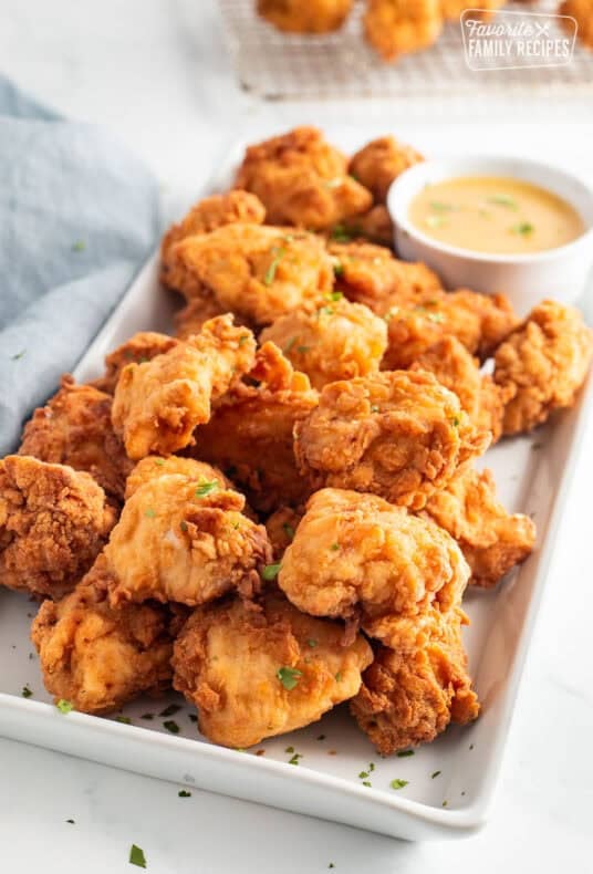 Mafa Chicken with dipping sauce on a platter.