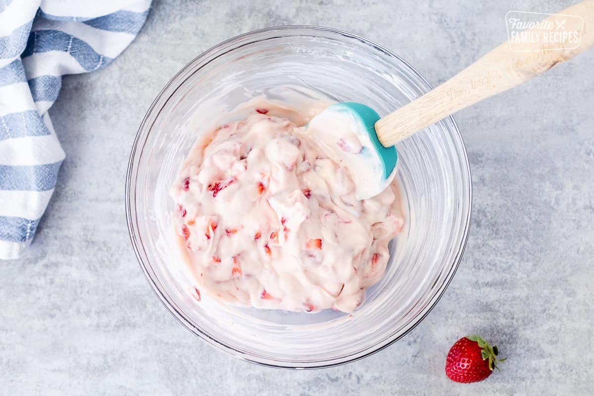 Glass bowl with strawberry cream cheese crepe filling.