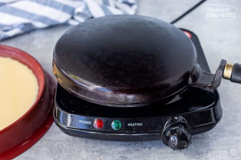 Crepe pan heating on electric plate.
