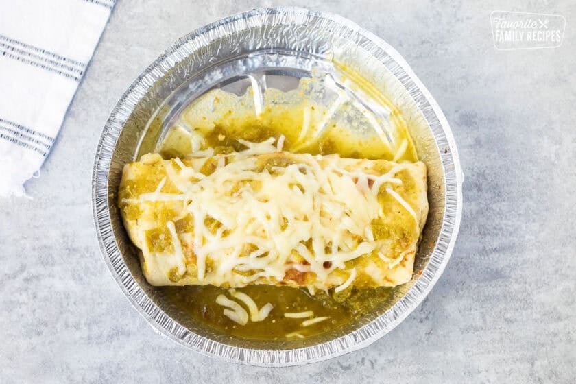 Melted cheese on top of sweet pork burrito.