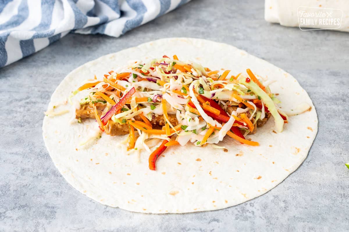 Flour tortilla with peanut chicken and slaw.