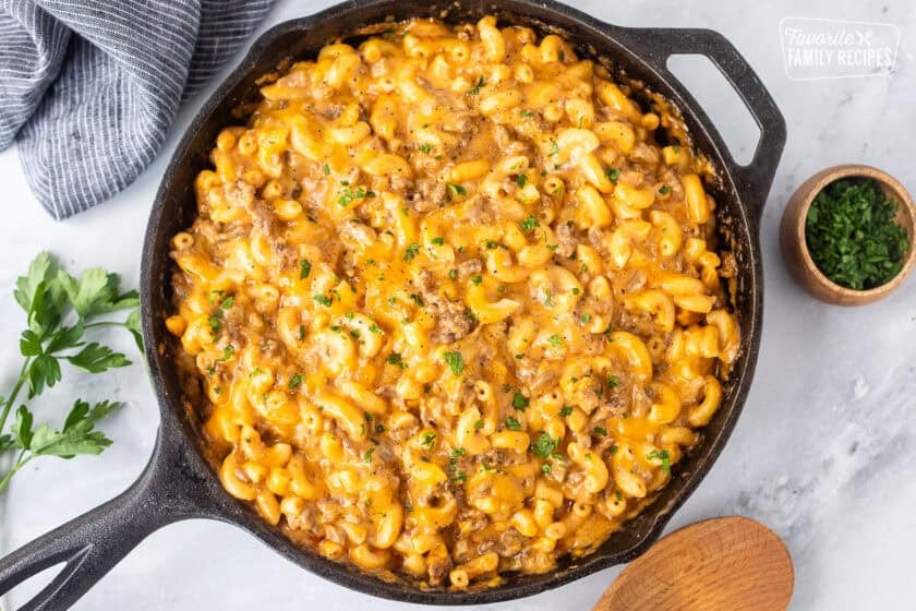 Skillet with Beefaroni and garnished with fresh parsley.