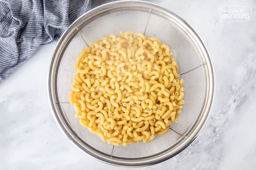 Cooked macaroni pasta in a colander.
