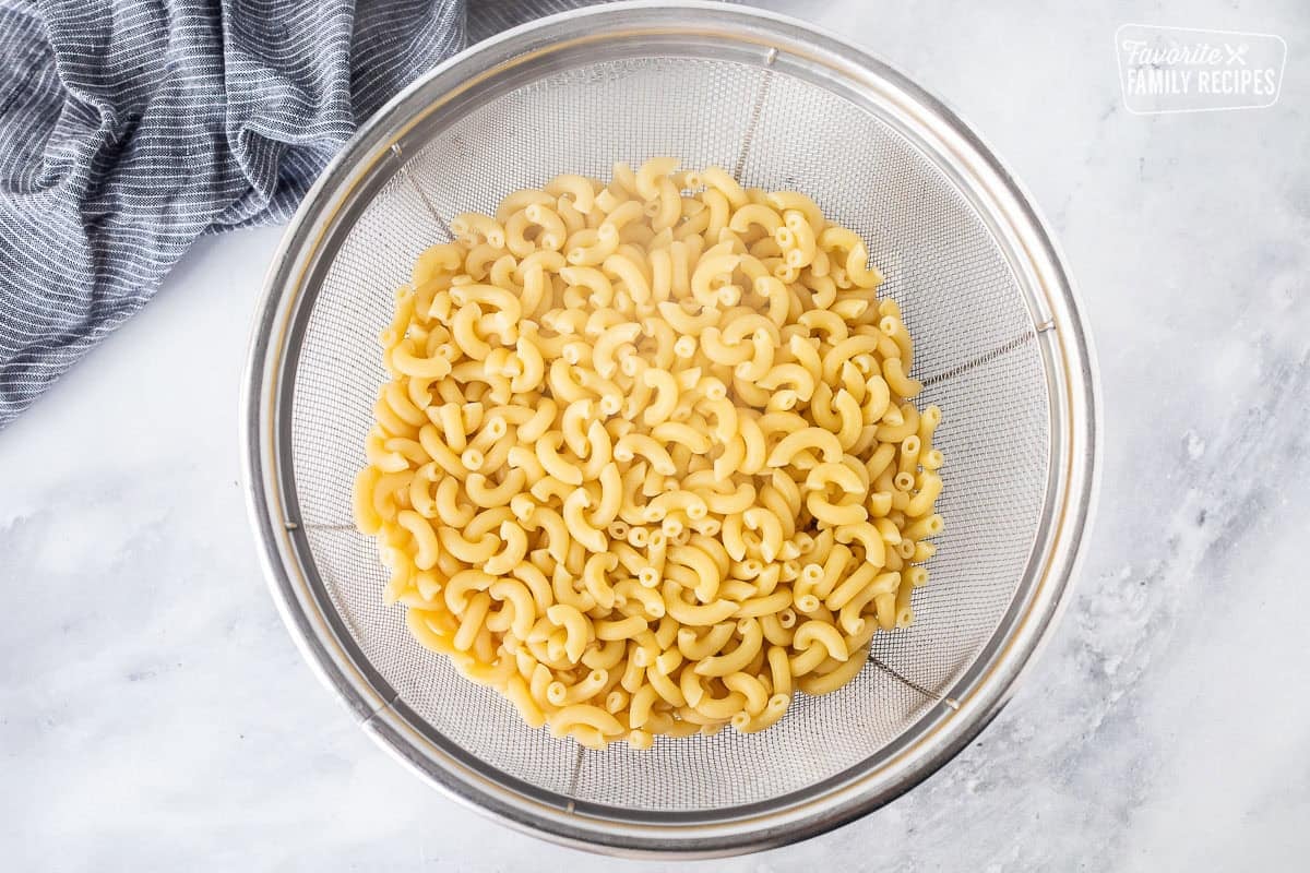 Cooked macaroni pasta in a colander.