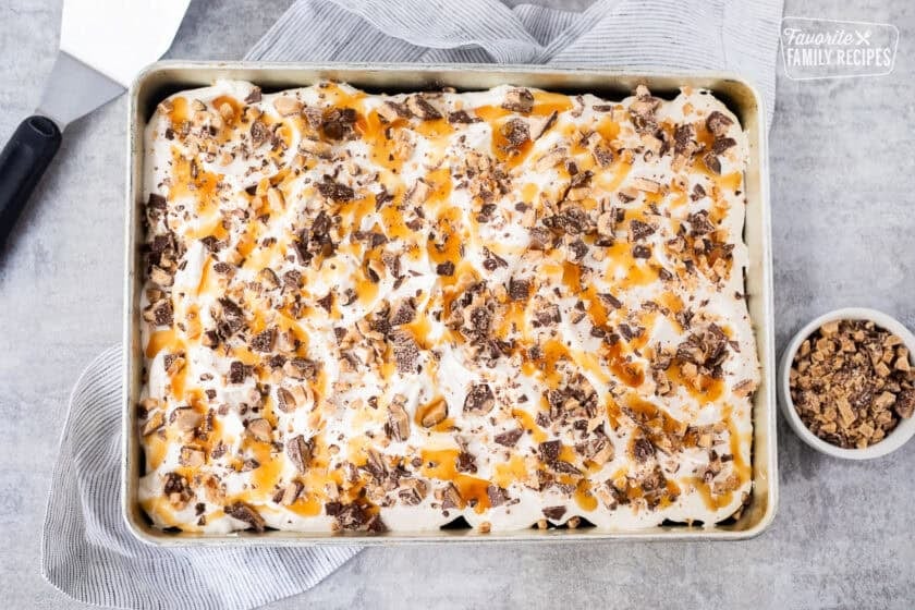 Better Than Sex Cake topped with crushed Heath bars and caramel sauce.
