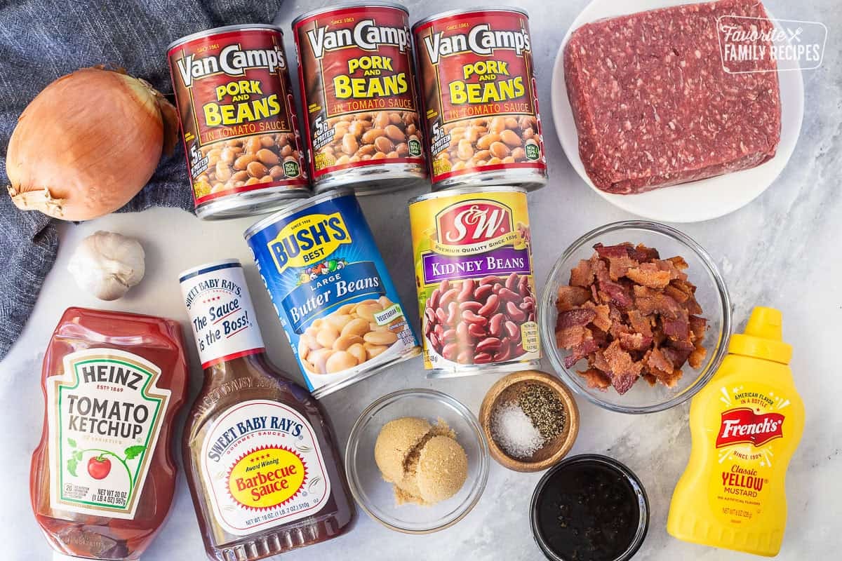 These Crockpot baked beans are the perfect side dish for your next potluck or BBQ. They are sweet, savory, beefy, hearty, and oh so delicious! Ingredients to make calico beans including ground beef, cans of pork and beans, onion, garlic, ketchup, barbecue sauce, butter beans, kidney beans, bacon, brown sugar, salt, pepper, molasses, and mustard.