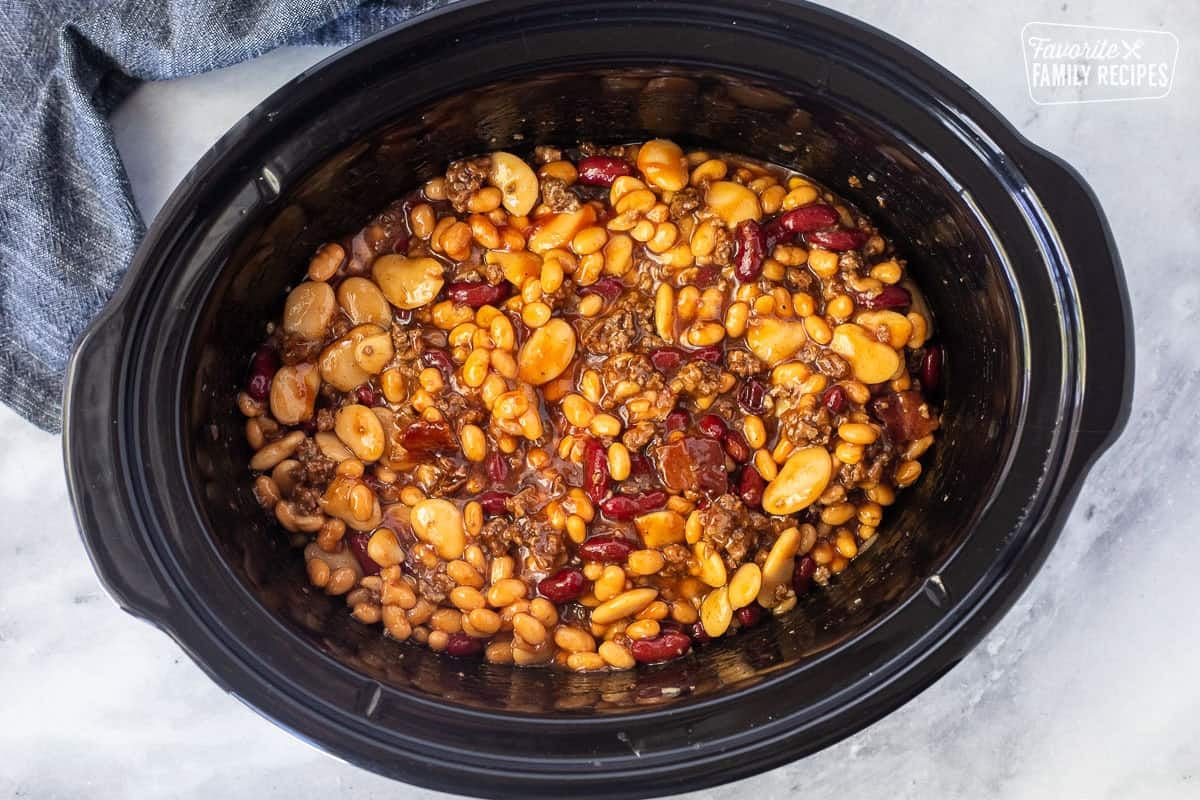 Crockpot with mixed ingredients for calico beans.