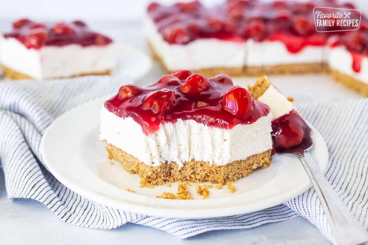 Slice of cherry delight recipe missing corner part with fork marks.