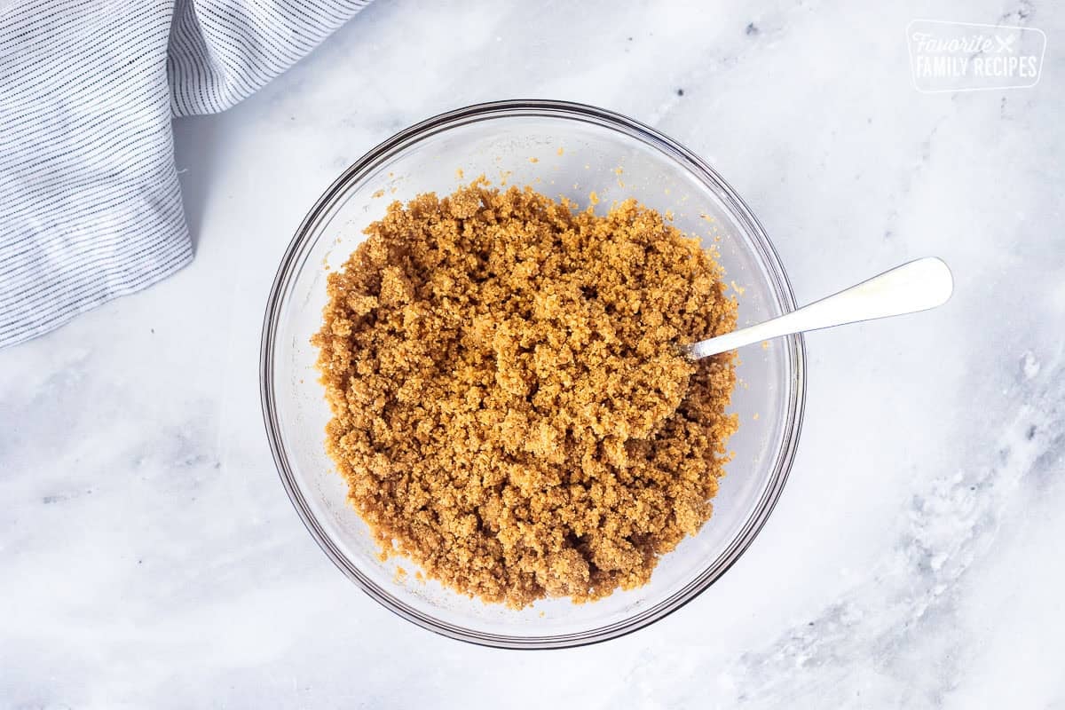 Small glass bowl of graham crackers mixed with butter.
