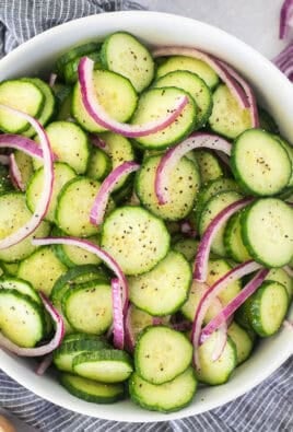 Bowl of cucumber vinegar salad with fresh cracked pepper.