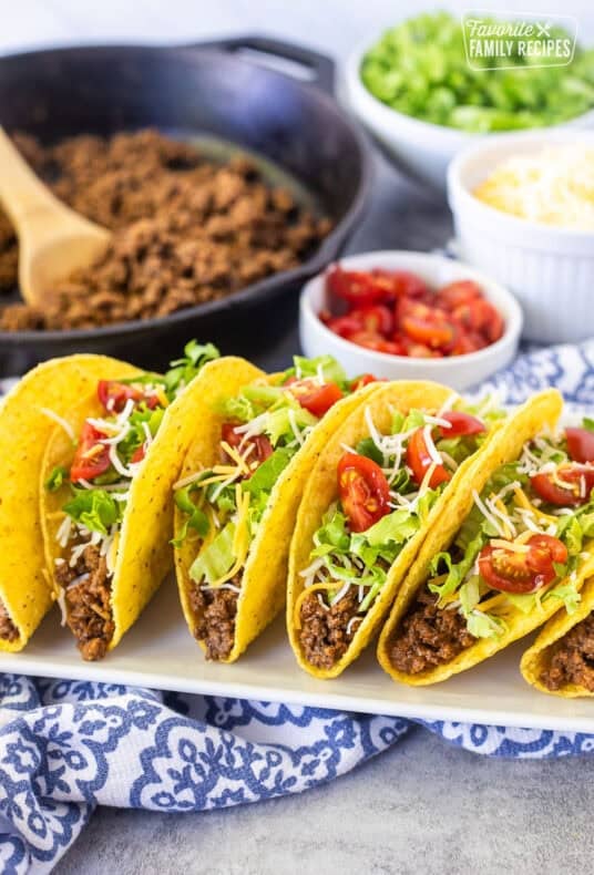 Crunchy ground beef tacos with seasoned ground beef, lettuce, cheese, and tomatoes.
