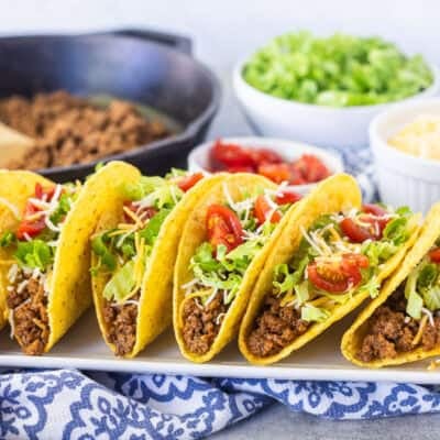 Crunchy ground beef tacos with seasoned ground beef, lettuce, cheese, and tomatoes.