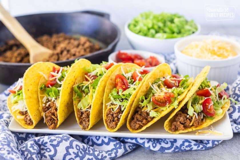 Crunchy ground beef tacos with seasoned ground beef, lettuce, cheese, and tomatoes.