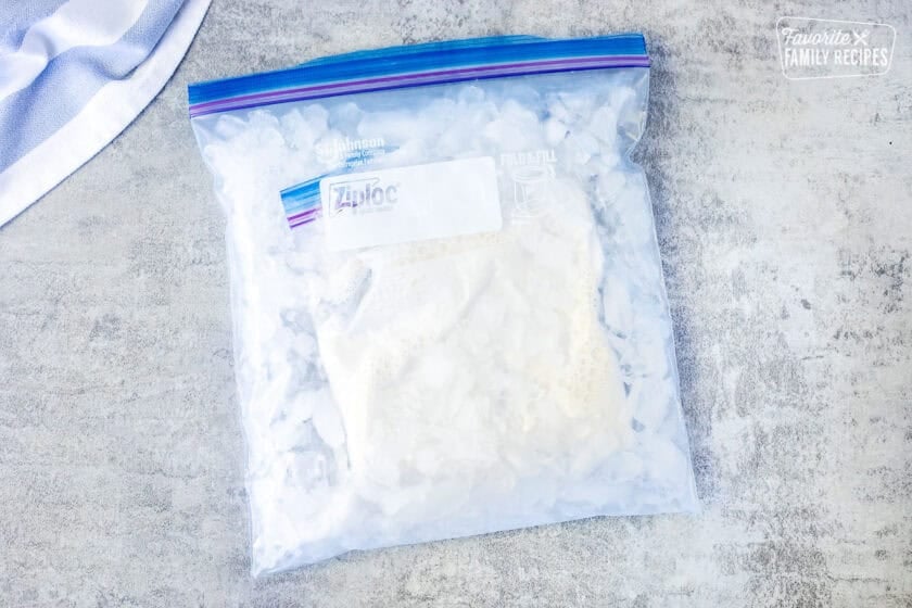 Small ice cream bag sealed into a large gallon size bag of ice and rock salt.