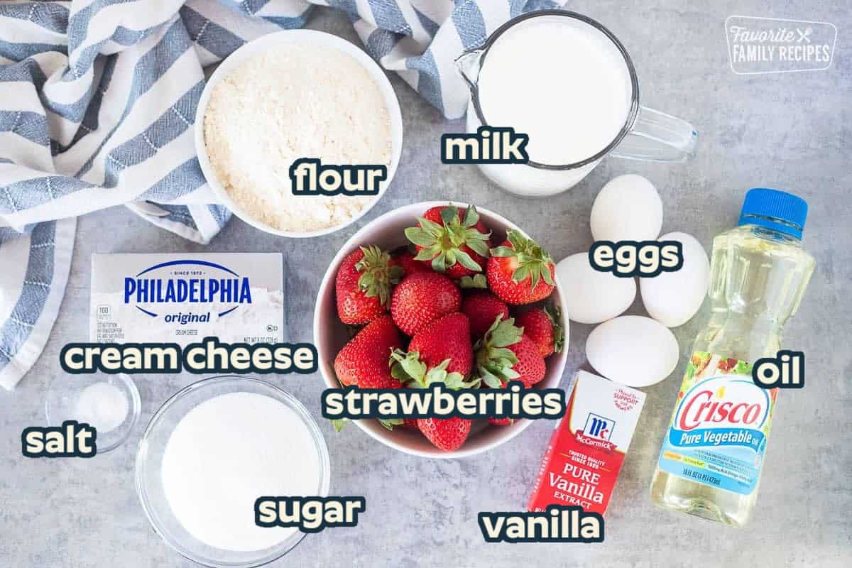 Ingredients to make Strawberry crepes including strawberries, milk, eggs, oil, vanilla, sugars, salt, cream cheese and flour.