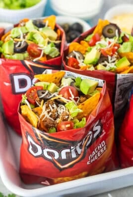 Bags of walking tacos with nacho cheese Doritos, seasoned ground beef, cheese, lettuce, tomatoes, olives and avocado.