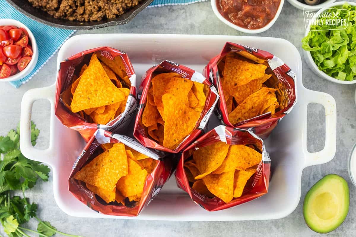 Small bags of nacho cheese Doritos chips open.