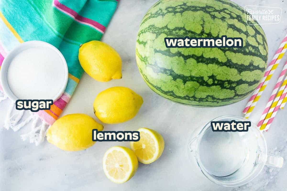 Ingredients to make watermelon lemonade including watermelon, water, sugar and lemons.