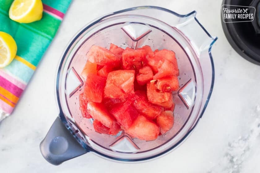 Blender with watermelon pieces.