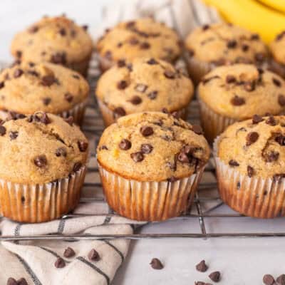 Banana Chocolate Chip muffins lined up on a cooling rack.