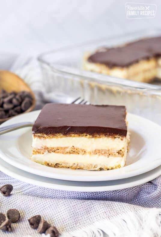 A slice of chocolate eclair cake double plated showing layers of the no bake dessert