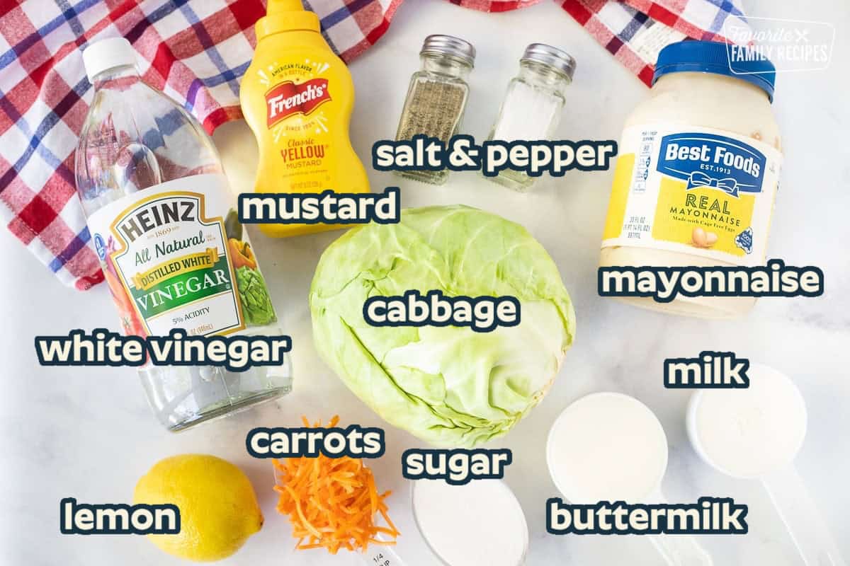 Ingredients to make Coleslaw including vinegar, yellow mustard, salt, pepper, mayonnaise, cabbage, carrots, lemon, buttermilk, sugar and milk.