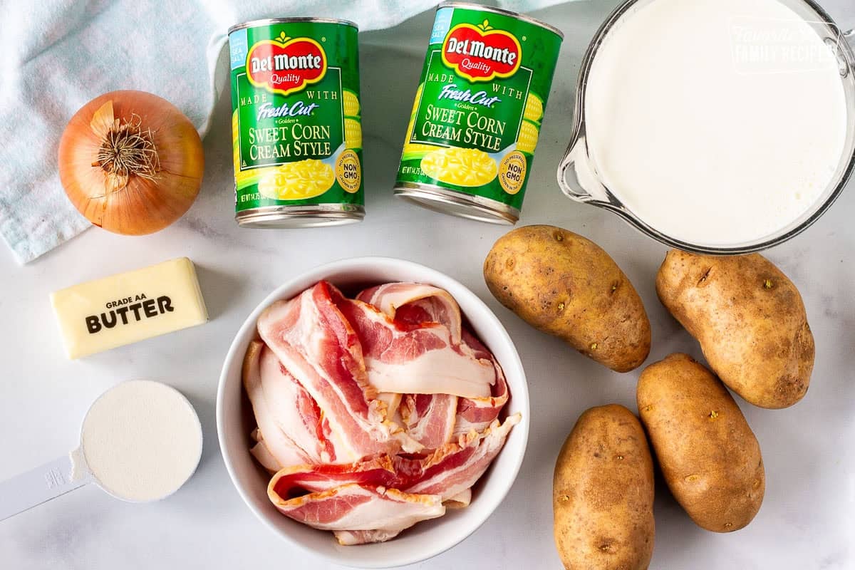 Ingredients to make Corn Chowder with Bacon including potatoes, bacon, cans of cream corn, half and half, butter and flour.