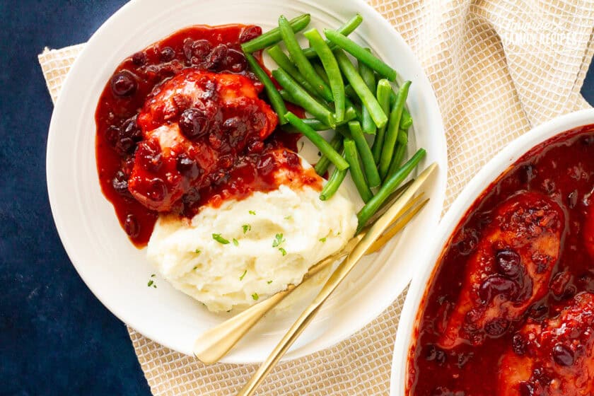 Plate of Cranberry Chicken, green beans and mashed potatoes.