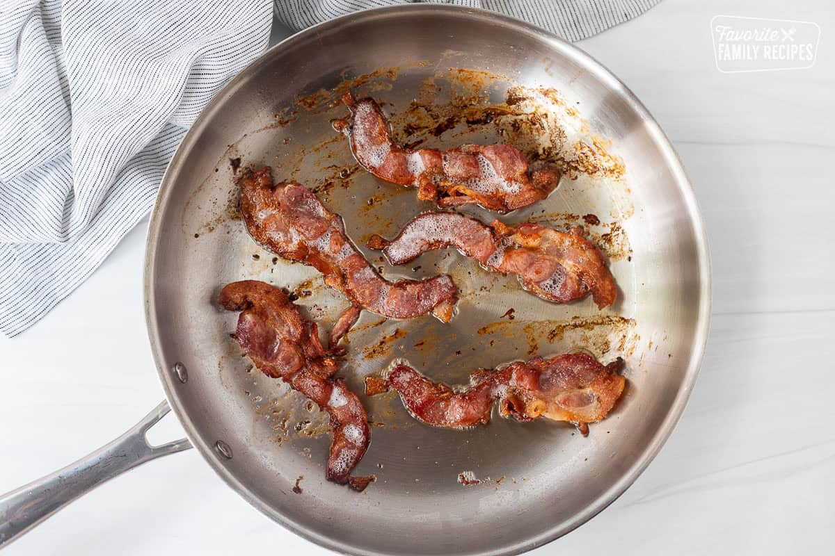 Skillet cooking bacon.