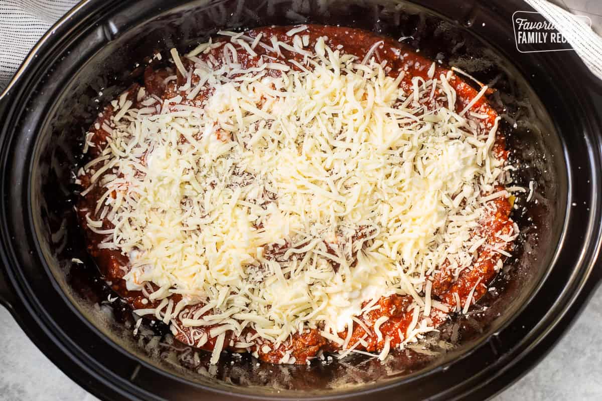 Cheeses on top of crockpot lasagna.